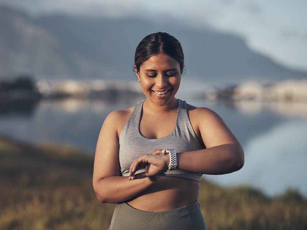 woman checking her smart watch after a run